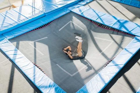 Man lying on the trampoline. active life Stock Photos