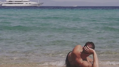 Man Lying At The Waterfront Stock Footage