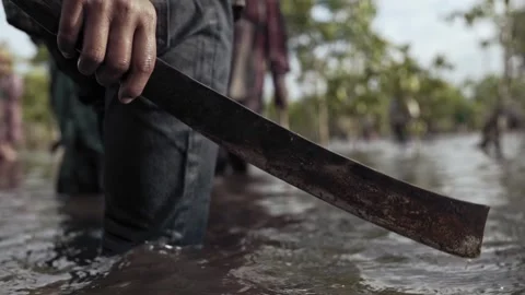 Man with machete in the river forest water Stock Footage 278273688