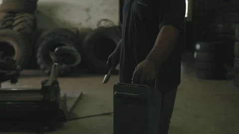 Man at machine in a garage Stock Footage 275075776