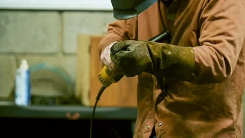 Man with a machine in his hand at work in a workshop Stock Footage 159182404