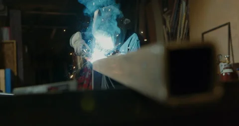 Man in Machine Shop Welding - Clip 001 Stock Footage 163942996