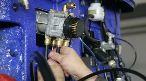 Man from machinery plant adjusting engine Stock Footage 68372431