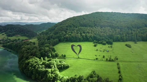 Man-made heart shape on green uphill. Love sign for planet Earth. Stock Footage 134405997