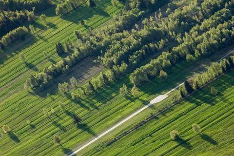 Man-made landscape. Furrowed fields. Structure of stripes and rows. Stock Photos
