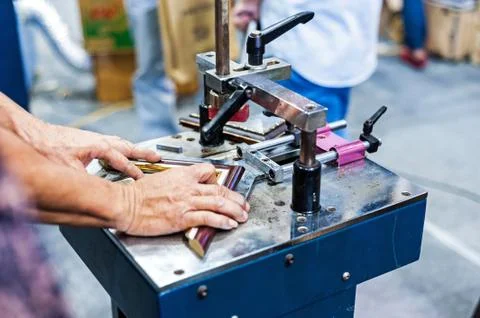 Man made picture frame with machine framer Stock Photos