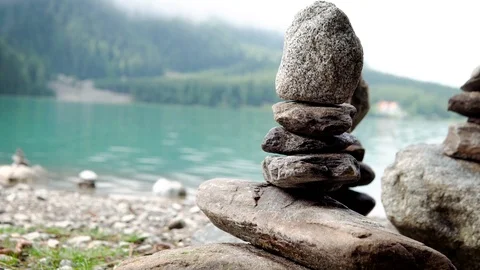 Man-made pile (or stack) of stones on anterselva lake dolomites italy 4k Stock Footage 115256288
