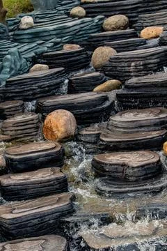 Man-made waterfall made of decorative stones Stock Photos