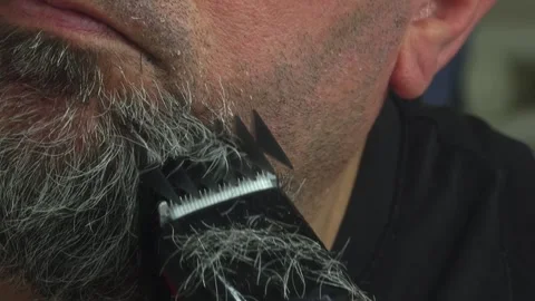 Man Maintaining His Beard with a Rechargeable Trimmer Device Stock Footage 337164594