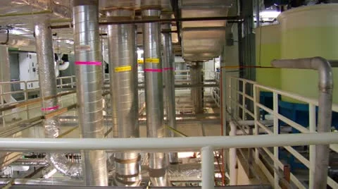 Man maintains equipment in complex machine room Stock Footage 21531892