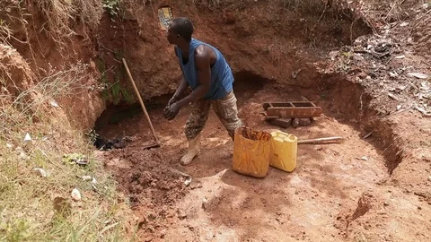 Man make Bricks from adobe pressing wet mud mixture into timber frame Stock Footage 109140204