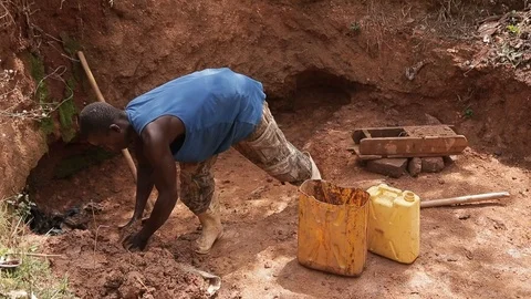 Man make Bricks from adobe pressing wet mud mixture into timber frame Stock Footage 109140215