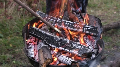 Man make a fire flames from firewoods for preparing grill Stock Footage 124326824