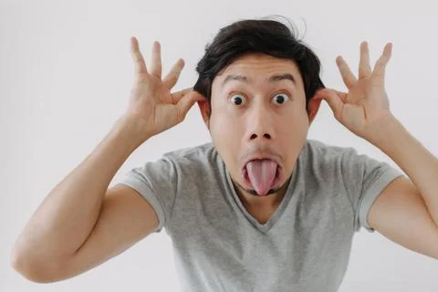 Man make funny teasing face for humor isolated on white. Foto stock