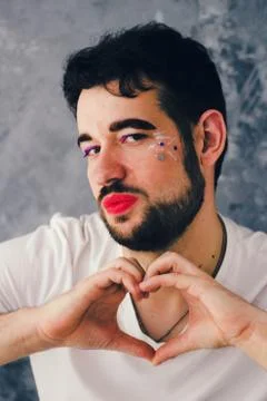 A man with make up - He is red lips and beard - transgender. Stock Photos