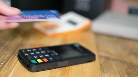 Man make purchase payment to a customer with credit card machine, cashless pay Stock Footage 145115579