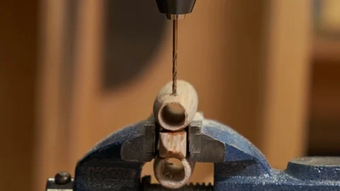 Man makes airplane model and spins hand drill into engine Stock Footage 127377474