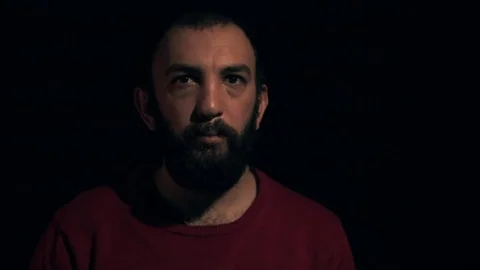 Man makes an angry face on a black background 動画素材 71173695