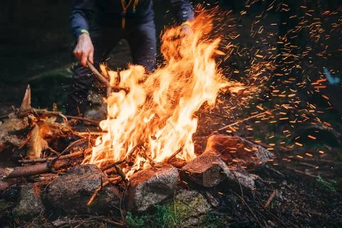 Man makes bonfire in forest Stock Photos
