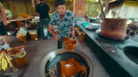  Man makes caramel on a fire in a large vat Stock-Footage 72927178