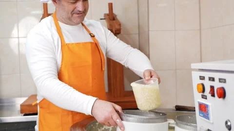 Man makes cheese, curd mass, fermentation of milk, process of producing homemade Stock Footage 210148899