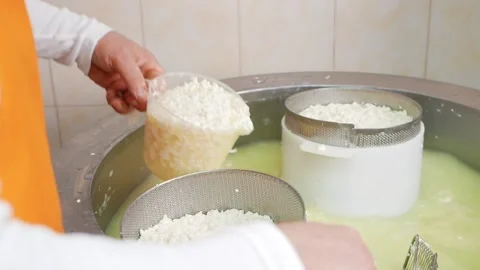 Man makes cheese, curd mass, fermentation of milk, process of producing homemade Stock Footage 210148964