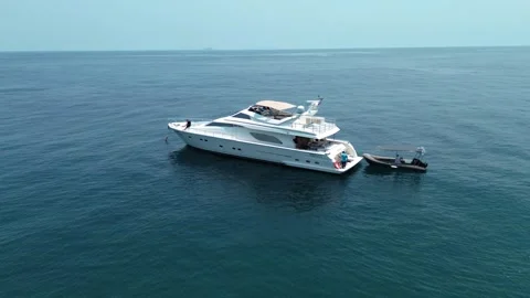 A man makes a circle around a private motor yacht using a drone Stock-Footage 258146107