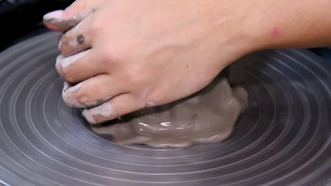 Man makes a clay pot or vase on a potter's wheel Video stock 324855999