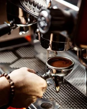 Man makes coffee in a coffee machine Stock Photos