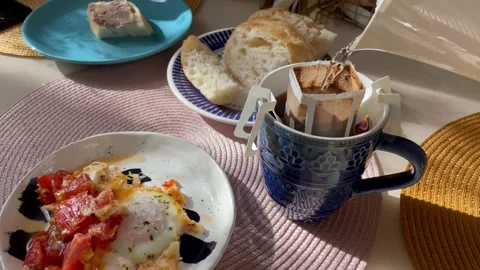 A man makes coffee. Pours boiling water into a drip bag coffee Stock Footage 208911700