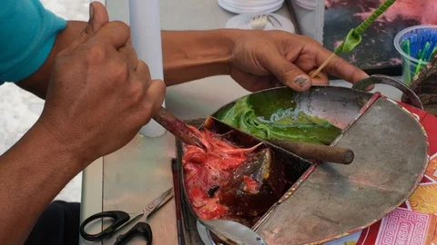 Man makes colorful sweets candy by hand close up view in Slow Motion Java, Asia Vídeos de archivo 102340765
