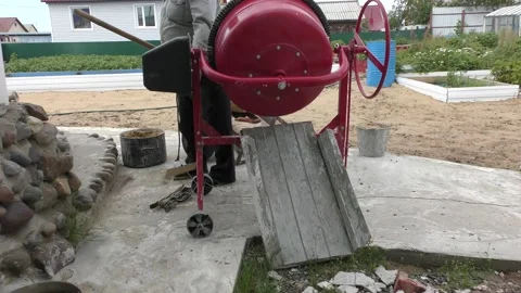 A man makes concrete mortar with a concrete mixer 스톡 동영상 136616183