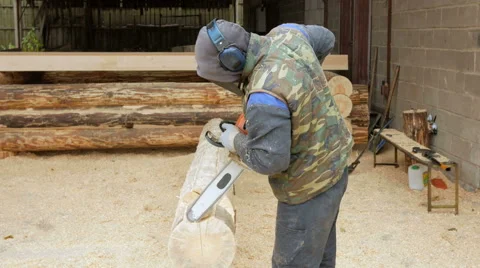 Man makes curly cutting wood Chainsaw. The log will be part of the future of the Stock Footage 69034136