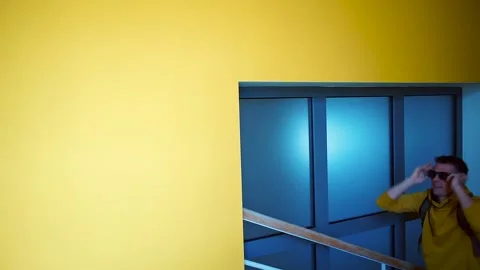 A man makes dance moves going to a new job on the stairs in the building. Stock-Footage 135650768