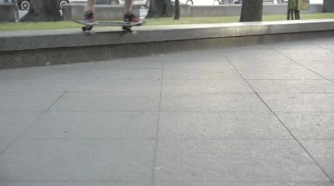 Man makes a difficult trick on a skateboard in a roadside park. Stock Footage 51754779