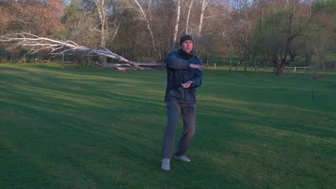 The Man Makes the Elements of the Kata of Karate in the Woods at Dawn in Early Stock Footage 74693690