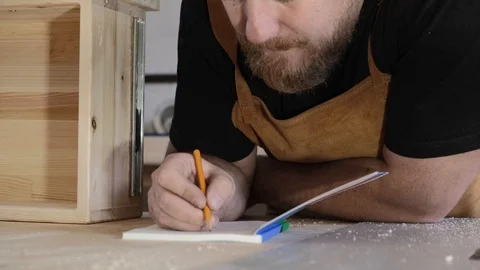 A man makes entries in the diary. Man, a professional makes notes in a notebook Stock Footage 113995063