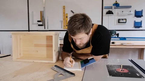 A man makes entries in the diary. Man, a professional makes notes in a notebook Stock Footage 113996532