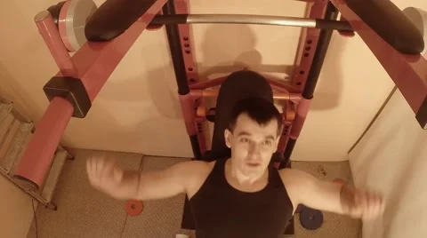 Man Makes Exercises With Bar on Wall Bars in the Room Top View Stock Footage 62473229