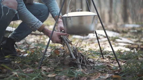 A man makes a fire in a beautiful spring forest Stock Footage 153031015