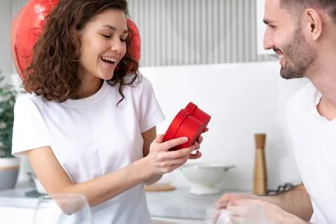 Man makes a gift at the Valentines day celebration Stock Photos