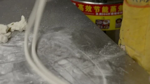 Man Makes Hand Stretched Noodles and Puts in Bowl in China Stock Footage 120532201