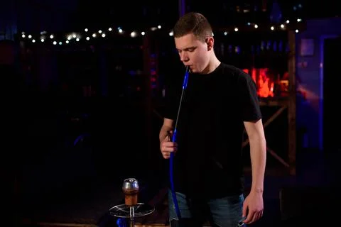 Man makes hookah. Modern hookah with coconut charcoal for relax and shisha smoke Stock Photos