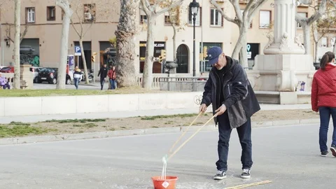 A man makes huge soap bubbles on the main square Stock Footage 101269678