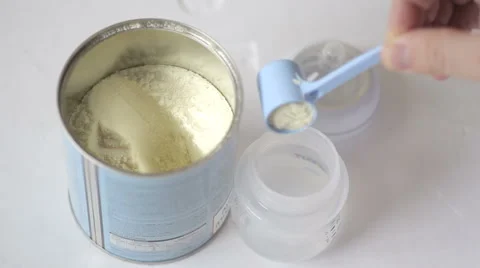 Man makes infant milk formula for a baby Stock Footage 59244100