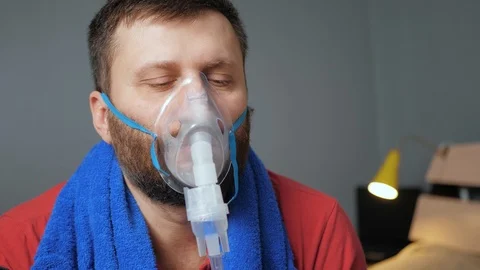 Man makes inhalation using nebulizer. Slow motion and close-up Stock-Footage 123275468