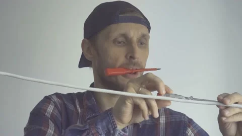 A man makes marks on the wire with a marker Stock Footage 155361422