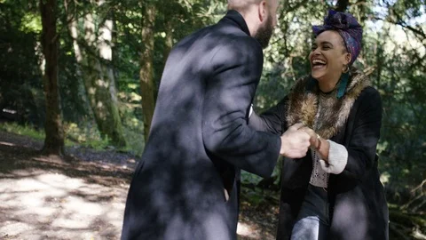 Man makes a marriage proposal to his girlfriend and she accepts whilst walking i Stock Footage