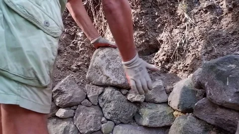 A man makes masonry. Somewhere in a tropical village. Video stock 122909620