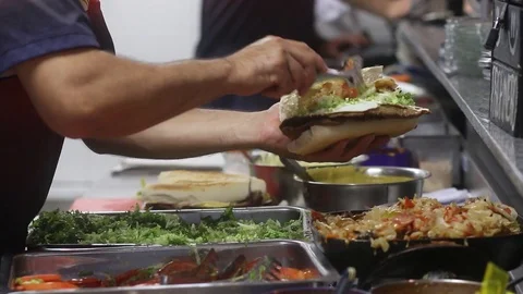 Man makes Milanese sandwich at a local food, typical Argentine food 스톡 동영상 123799877